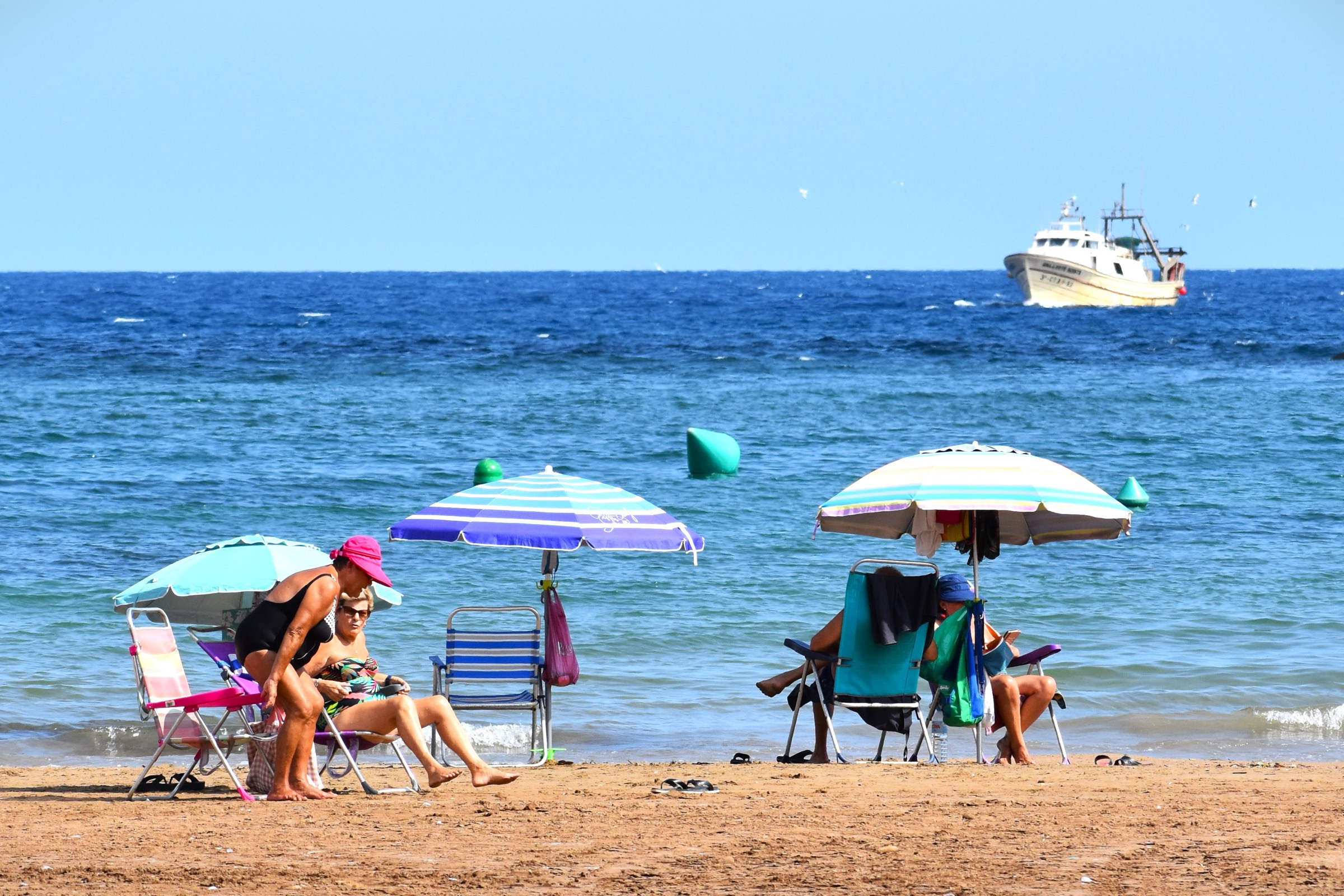 A fishing boat passing the beach at Puerto de Mazarrón