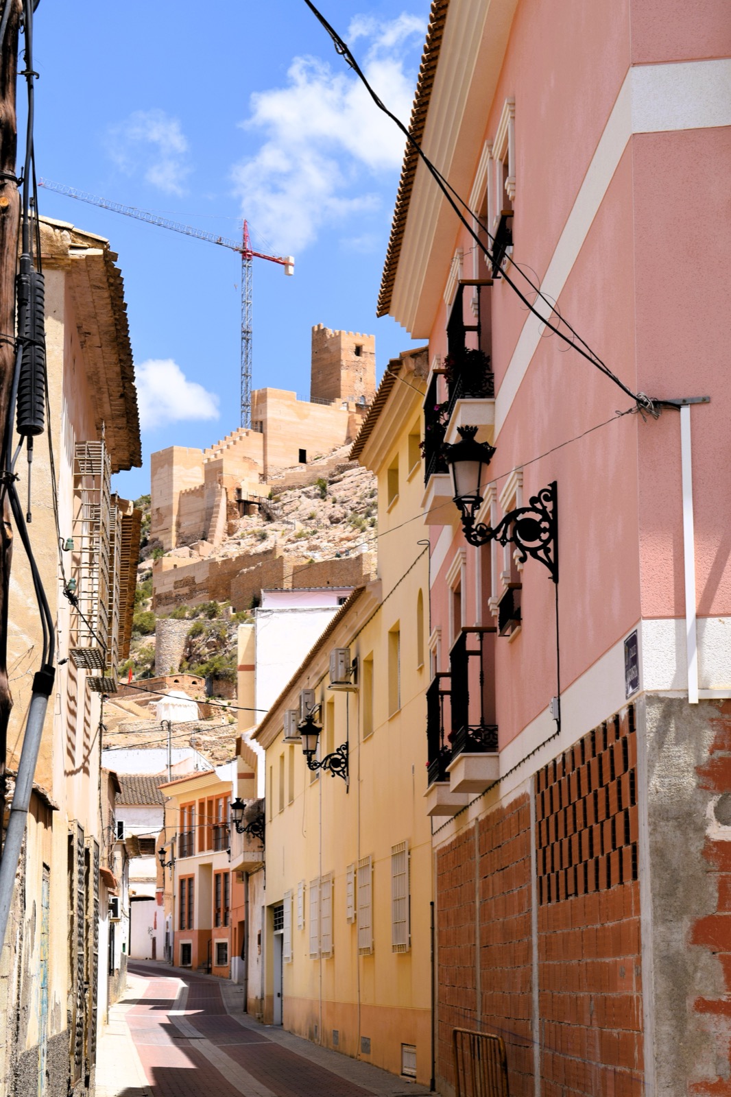 An Alhama de Murcia street with the castle beyond