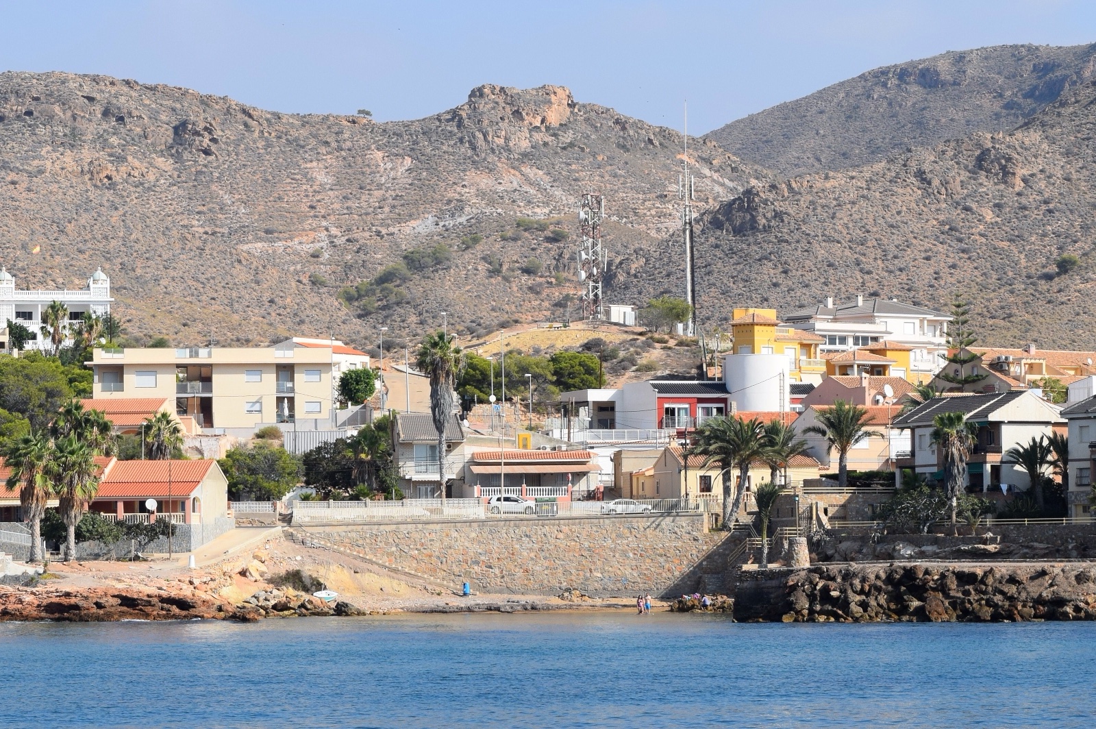 The village of Isla Plana with palms and mountains, viewed from the sea