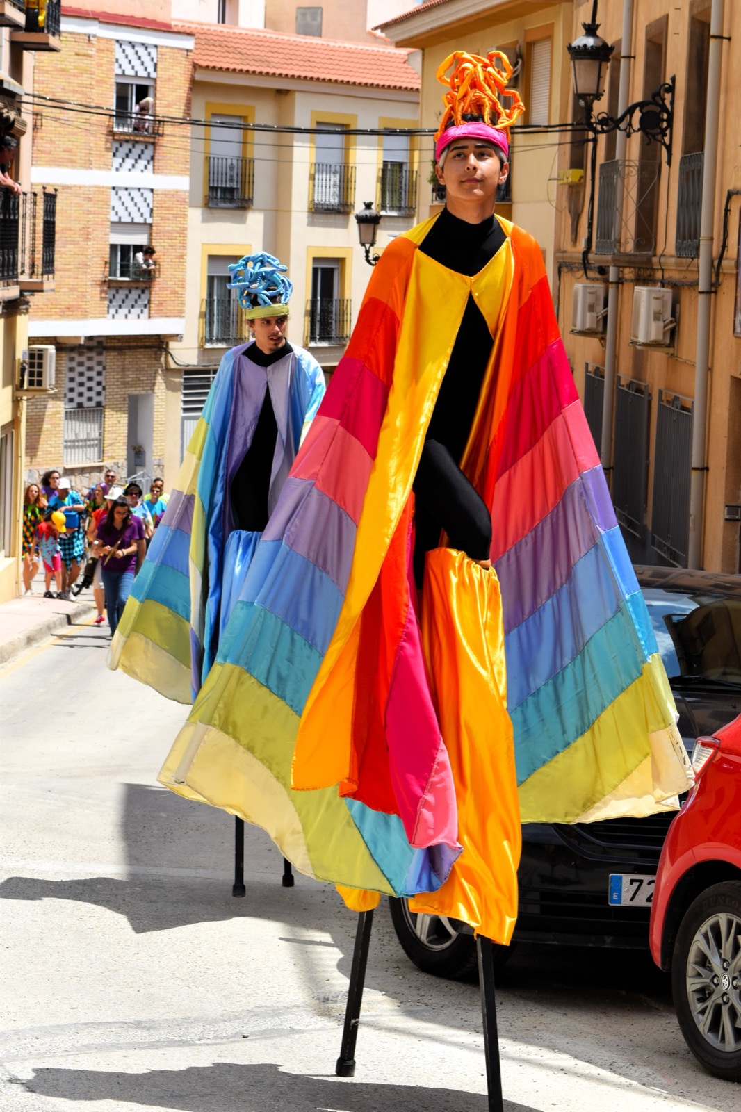 Stilt walkers in colourful capes at the Fiestas de Los Mayos, Alhama de Murcia