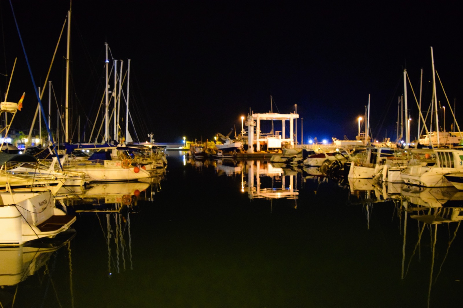 Night reflections of the harbour lights on the water in the marina at Puerto de Mazarrón