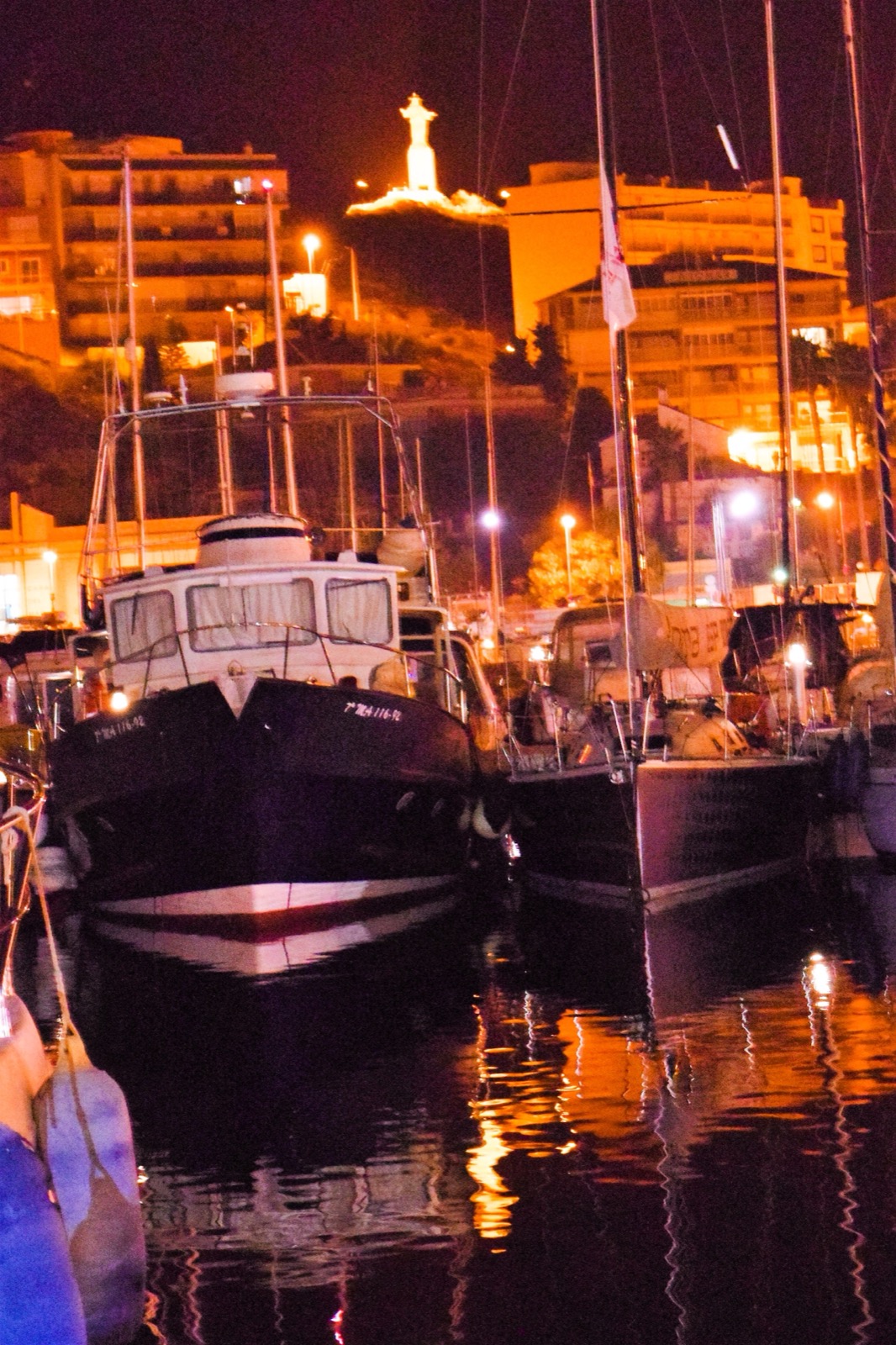 Night reflections of the harbour lights on the water in the marina at Puerto de Mazarrón