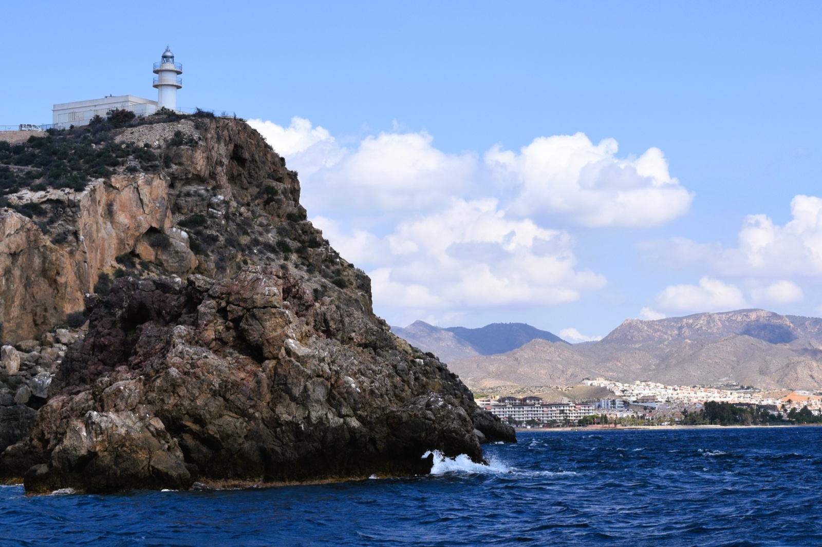 The lighthouse headland at Puerto de Mazarron viewed from a boat