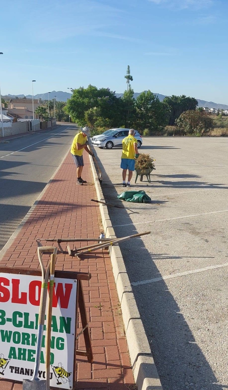 B Clean volunteers working along the pavement