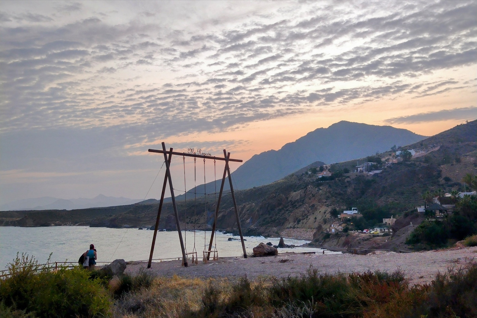 The Mi Rincon wooden swing overlooking Playa del Rincon at Bolnuevo at dusk