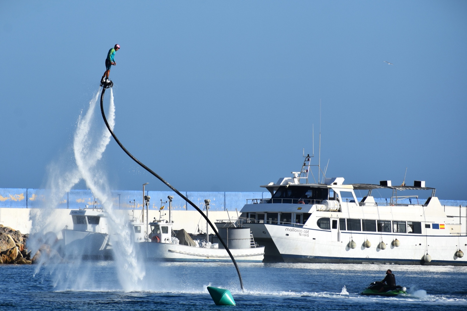 A flyboarder standing high on the water jet at Puerto de Mazarron harbour