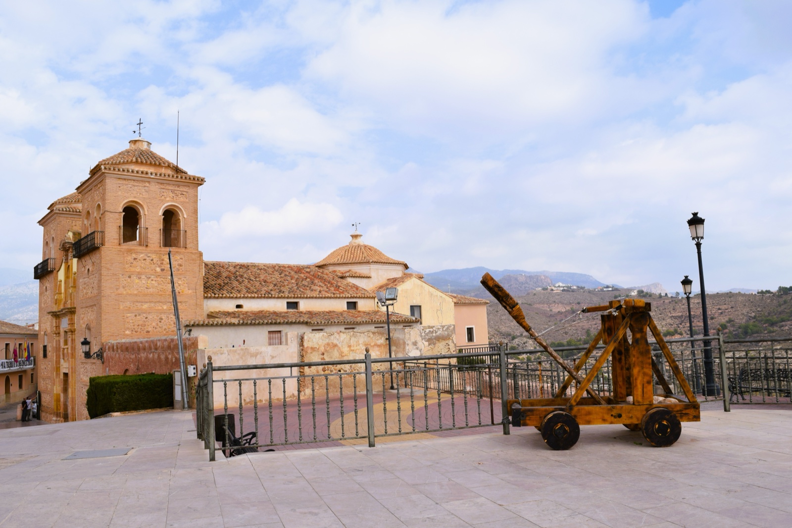 The Church of Santa Maria la Real and a wooden trebuchet in the plaza at Aledo