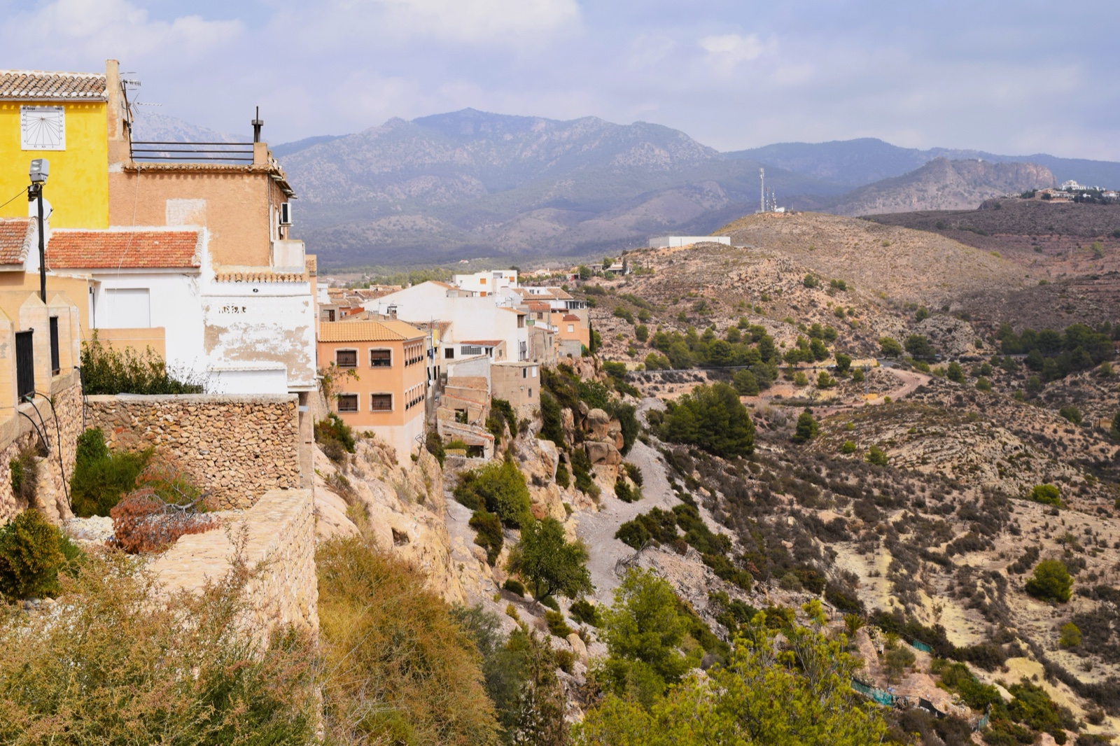 The houses of Aledo perched along the ridge with mountains behind
